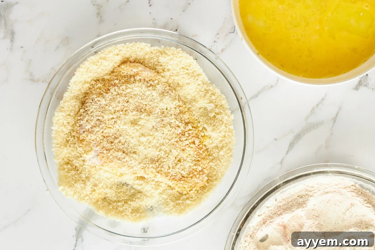 Raw breaded chicken in breadcrumbs.