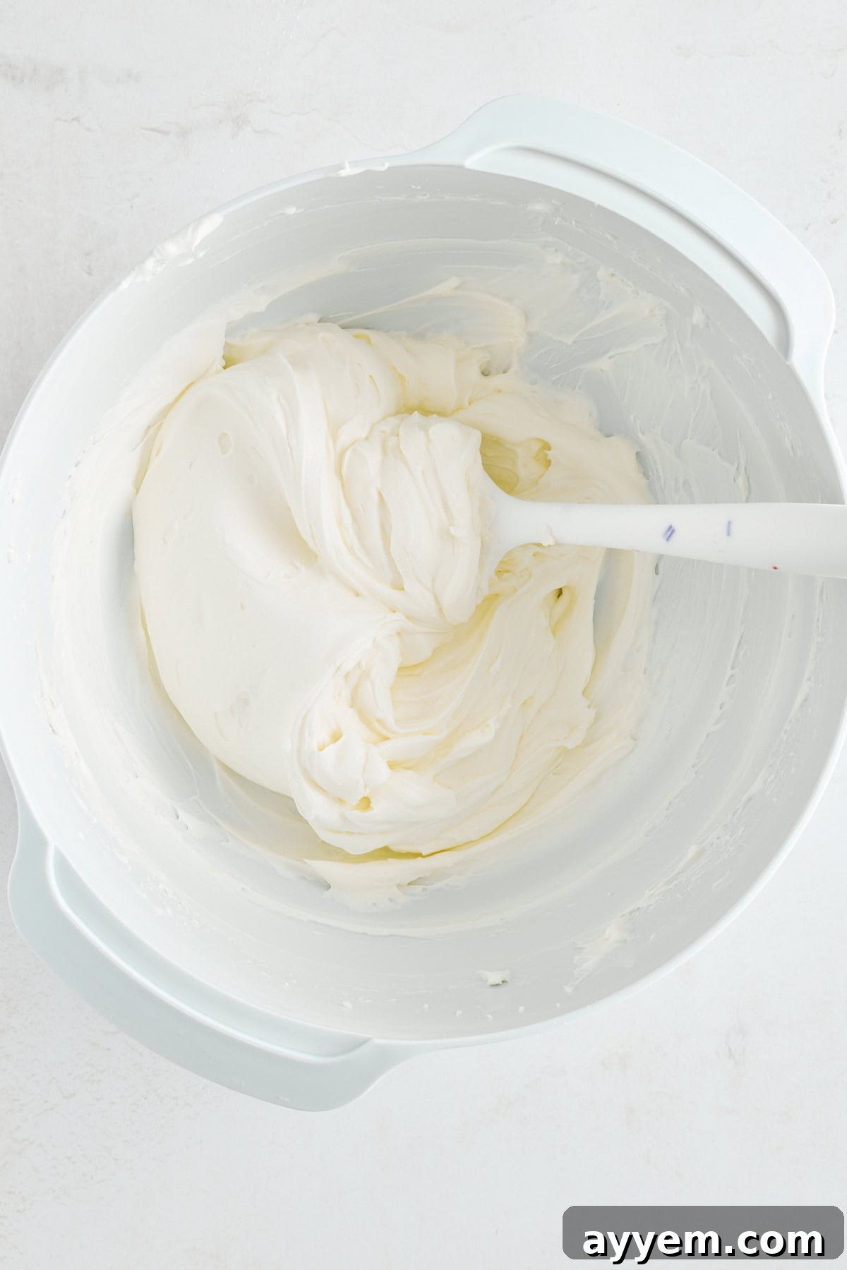 Cheesecake filling in a mixing bowl.