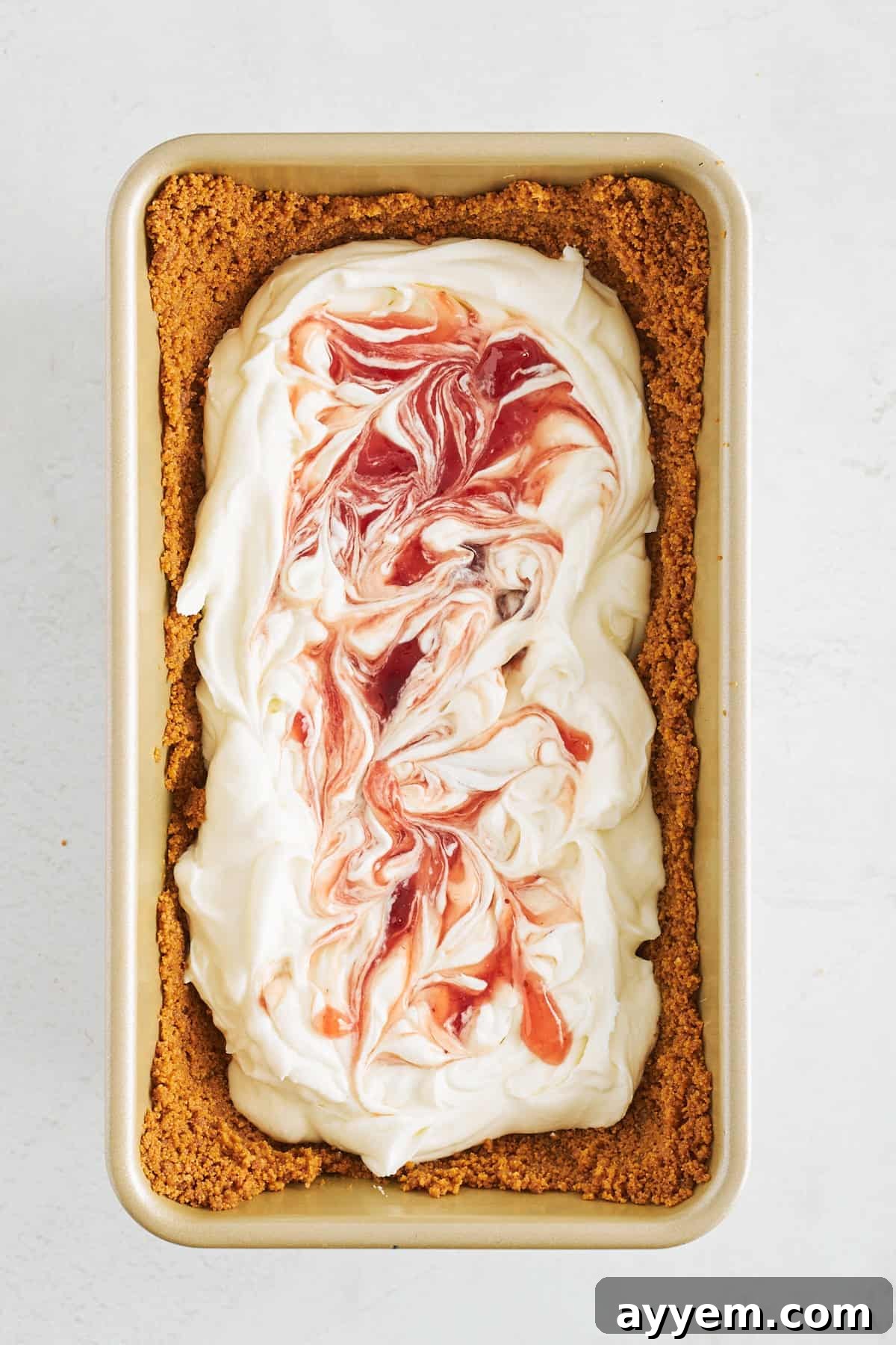 Strawberry preserves swirled into cheesecake filling in Biscoff crust.