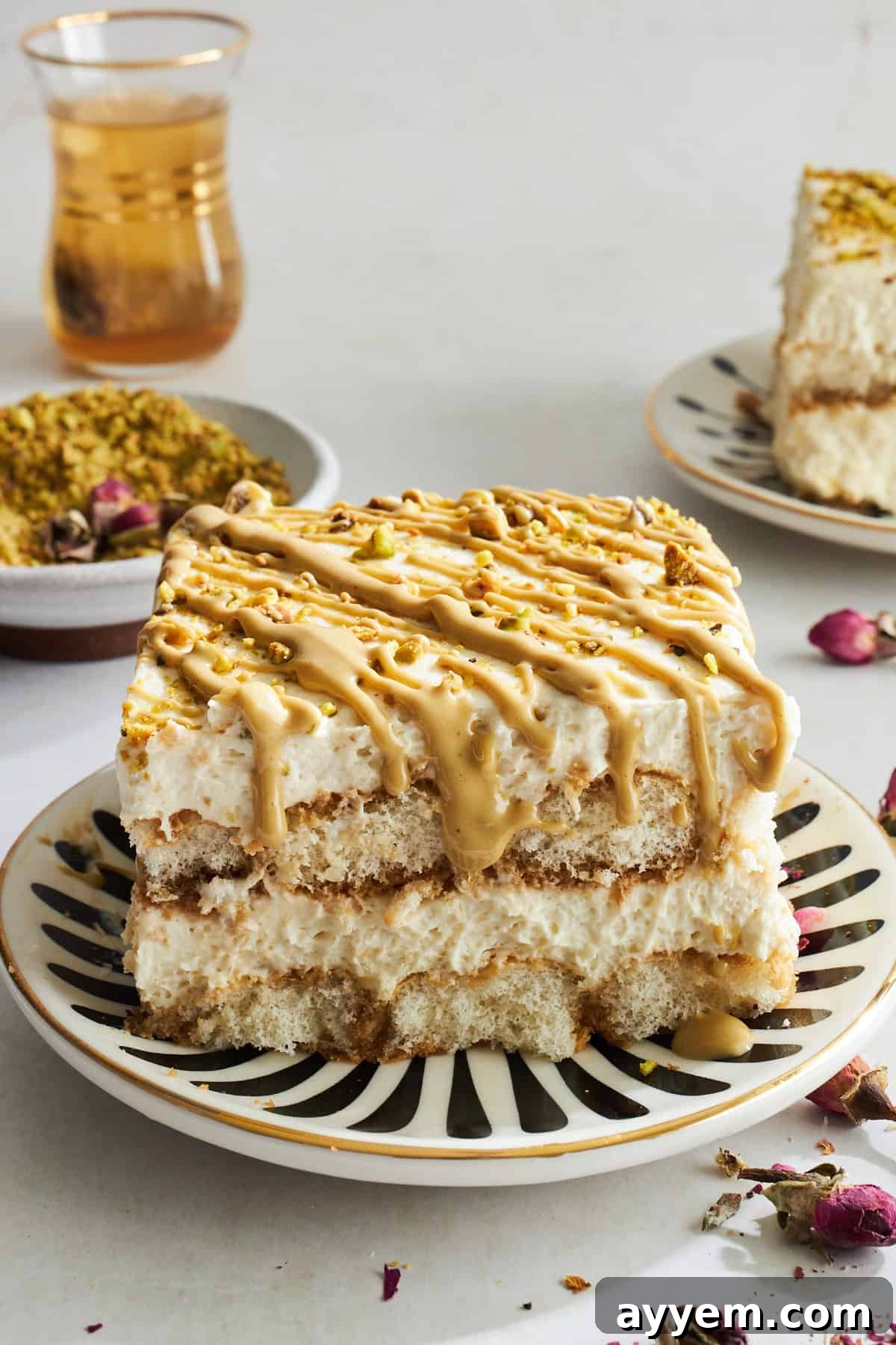 A slice of pistachio tiramisu on a plate, showing its layers.