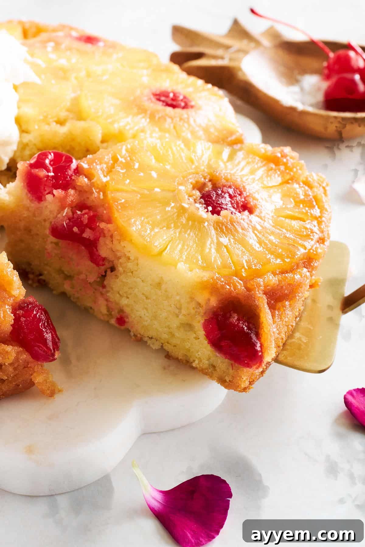 Close up image of a slice of pineapple upside down cake being lifted. 