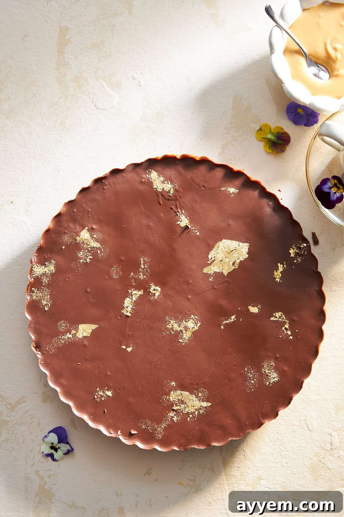 Overhead image of a beautifully arranged chocolate peanut butter kunafa, ready to be sliced.
