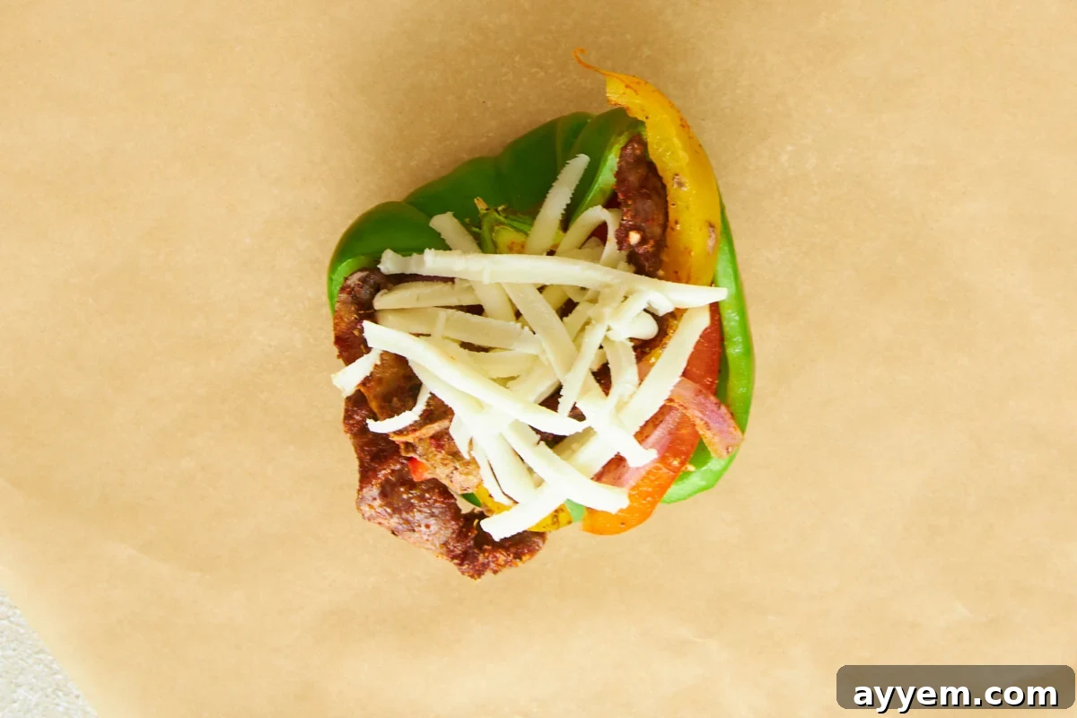 An uncooked Philly cheesesteak stuffed pepper.