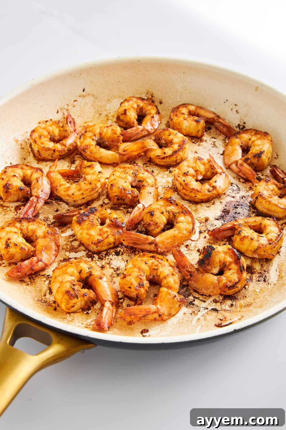 Blackened shrimp in a skillet, showing the perfectly seared crust.