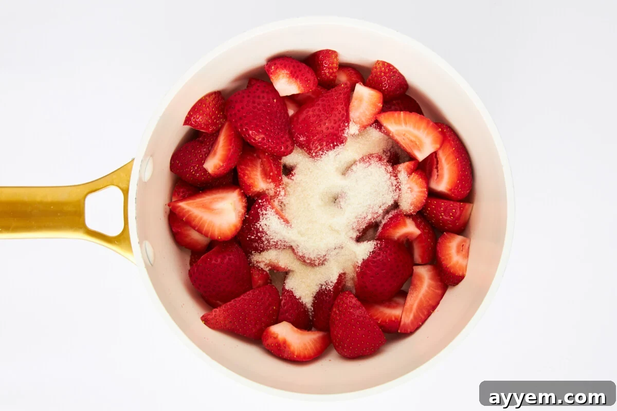 Sugar and strawberries in a saucepan.