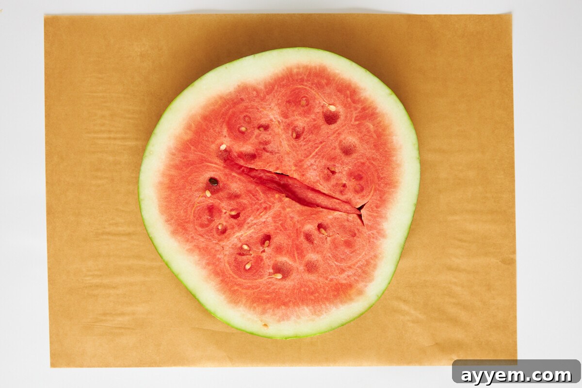 A perfectly round watermelon slice prepared as the pizza base.