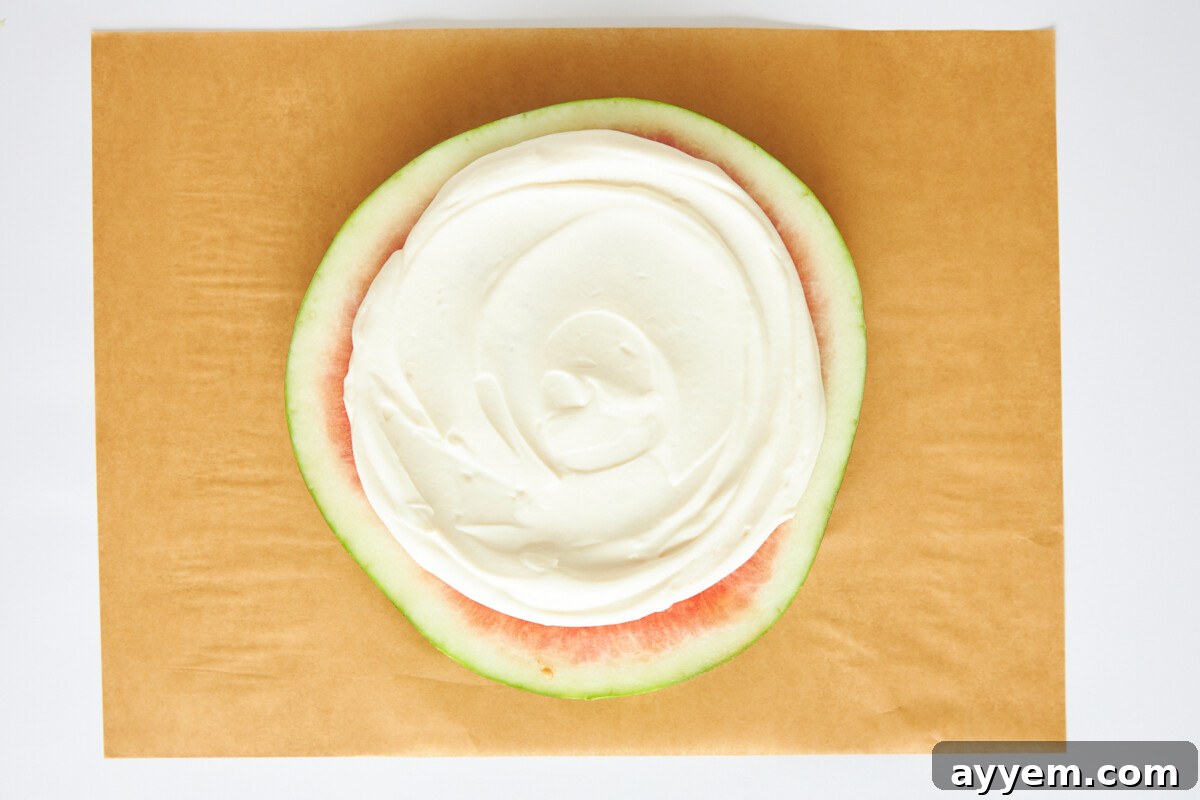 Yogurt and honey mixture spread evenly over the watermelon base.