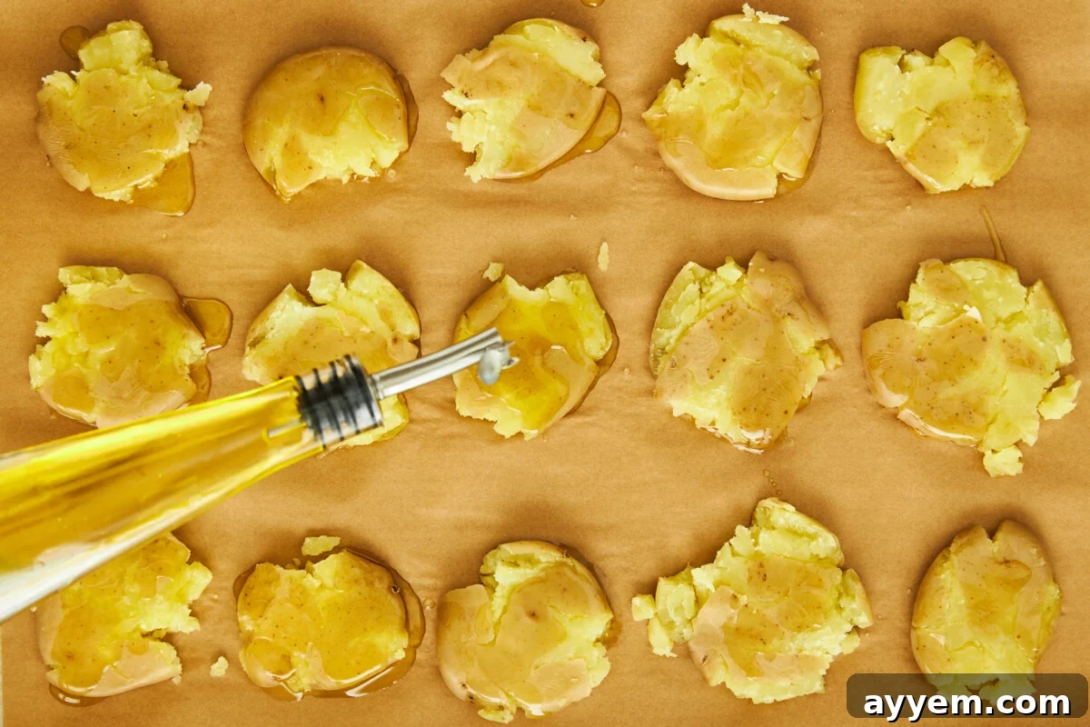 Boiled potatoes being topped with olive oil.