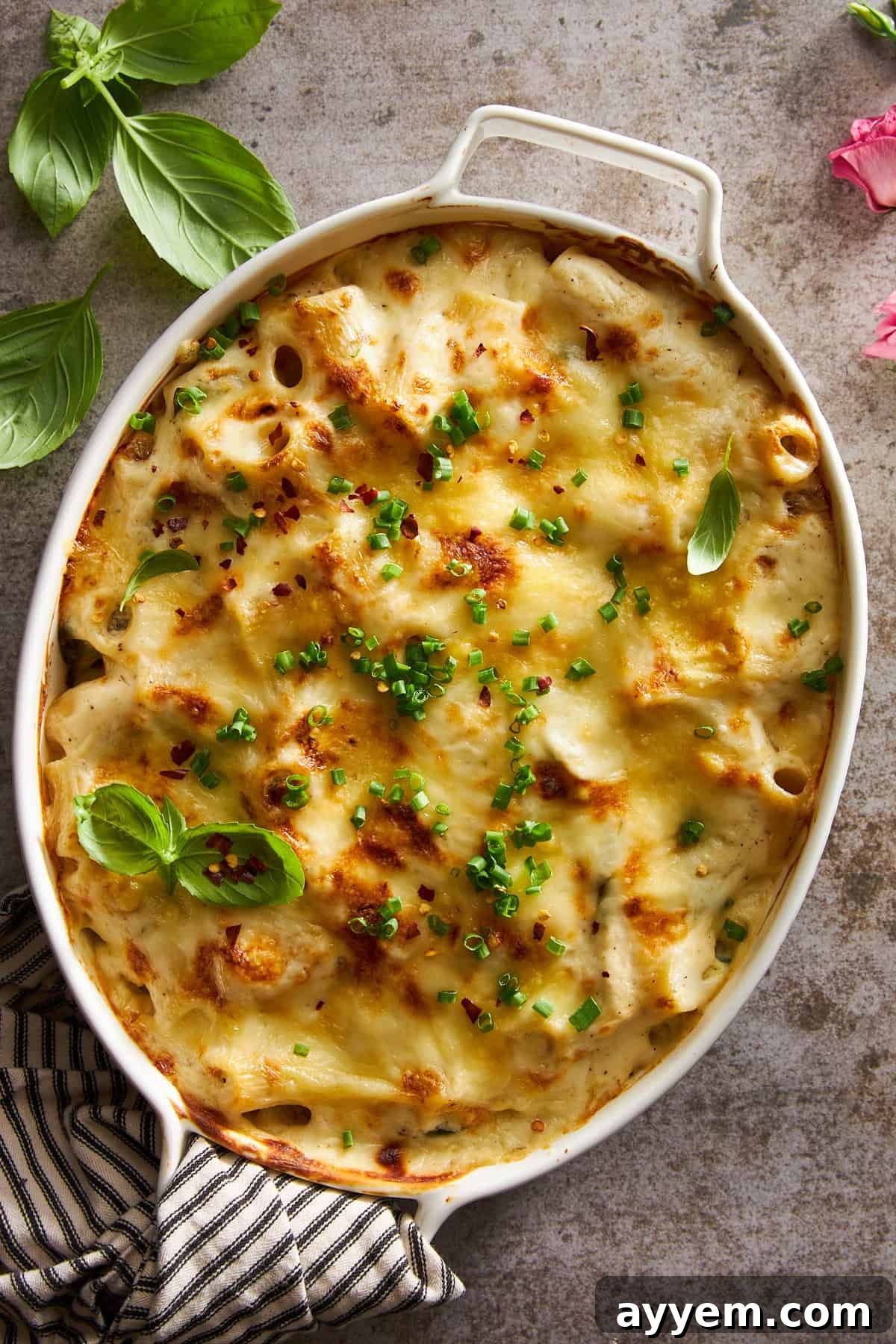 Overhead image of a beautifully golden and bubbly Chicken Spinach Pasta Bake, just removed from the oven.