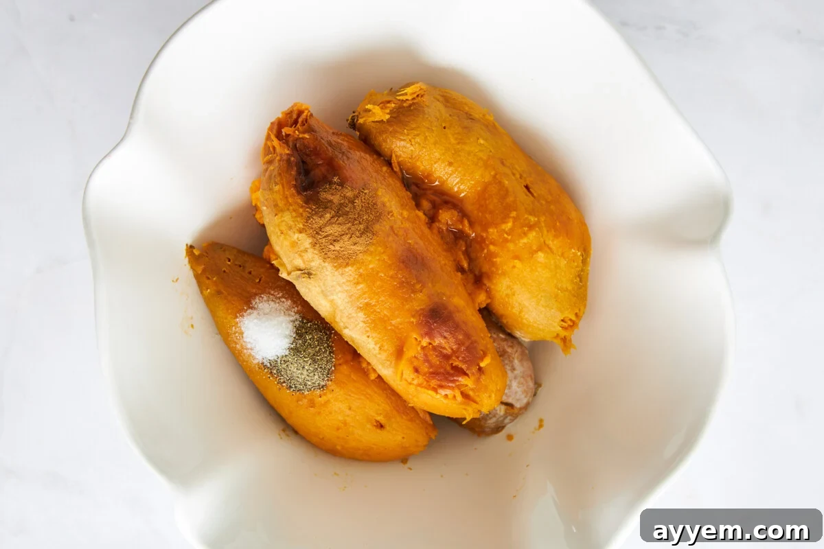 Peeled baked sweet potatoes in a bowl.