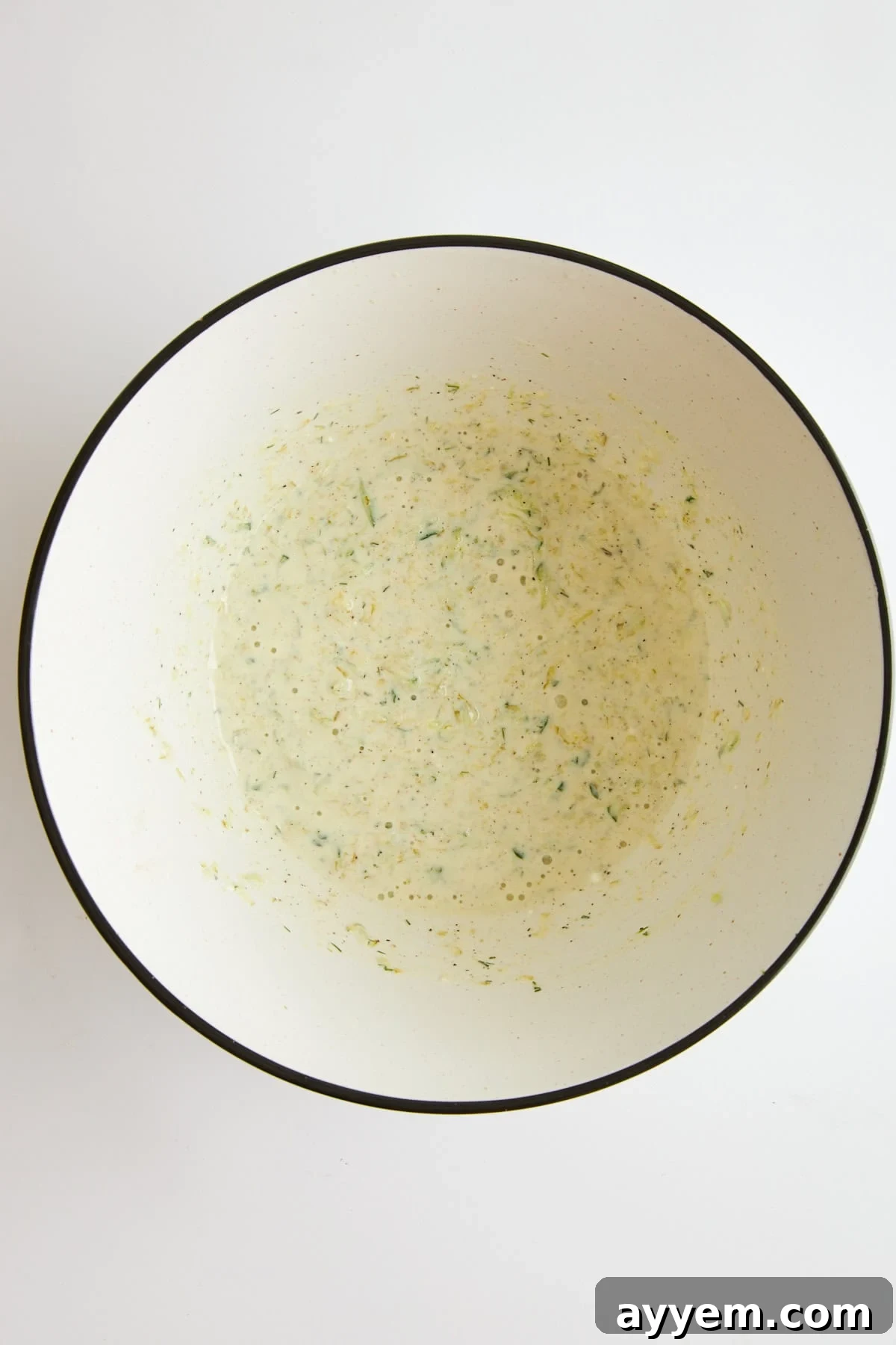 Tahini yogurt marinade mixed in a bowl, ready for chicken.