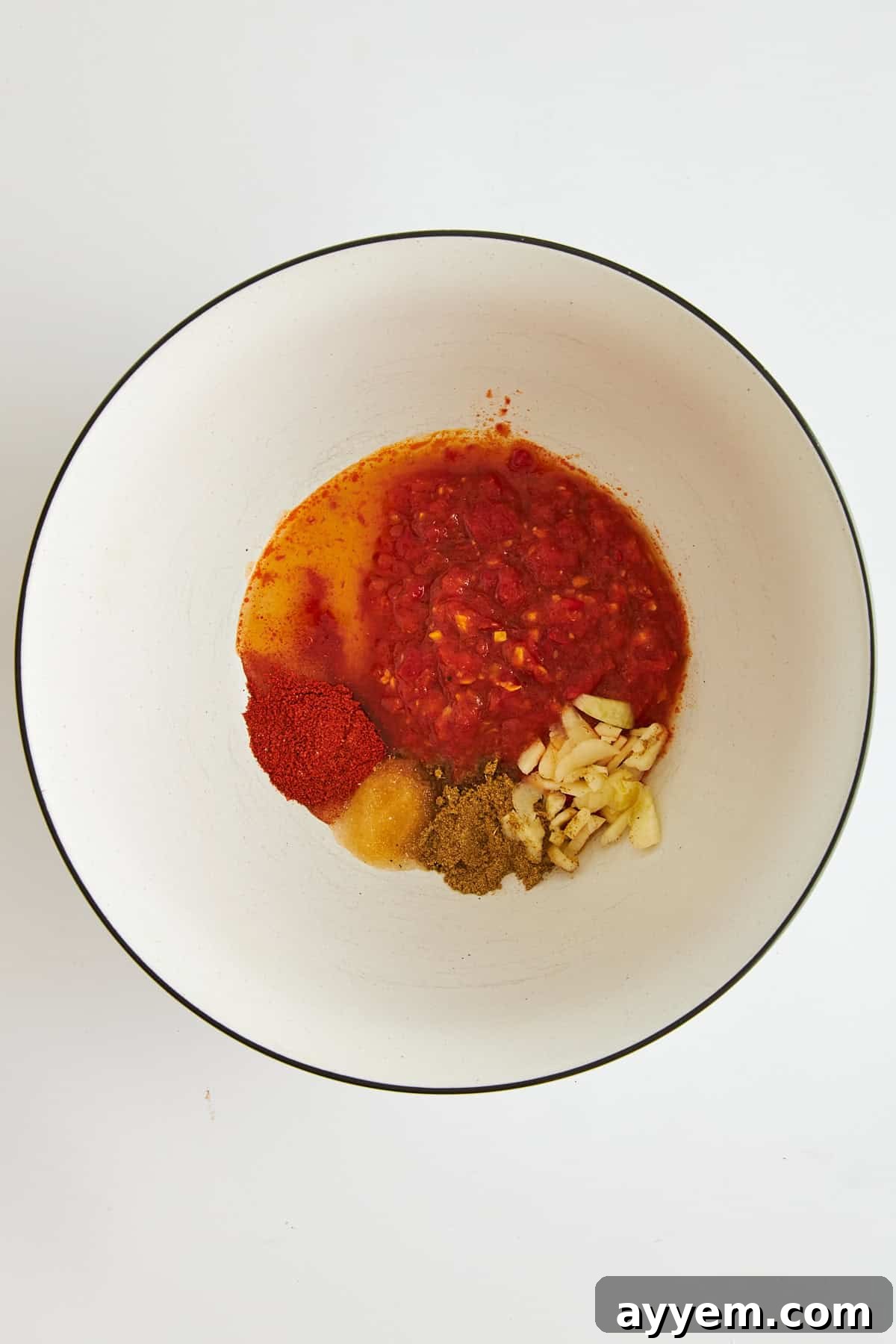 Ingredients for Harissa marinade, unmixed in a bowl.