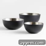 Three black stainless steel mixing bowls.