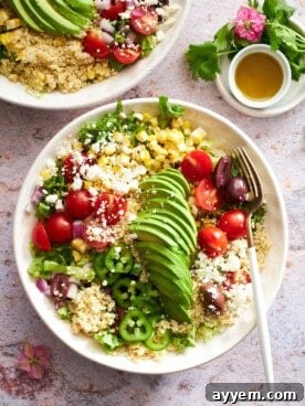 A colorful and robust Mexican quinoa salad, featuring various vegetables, quinoa, and a zesty dressing.