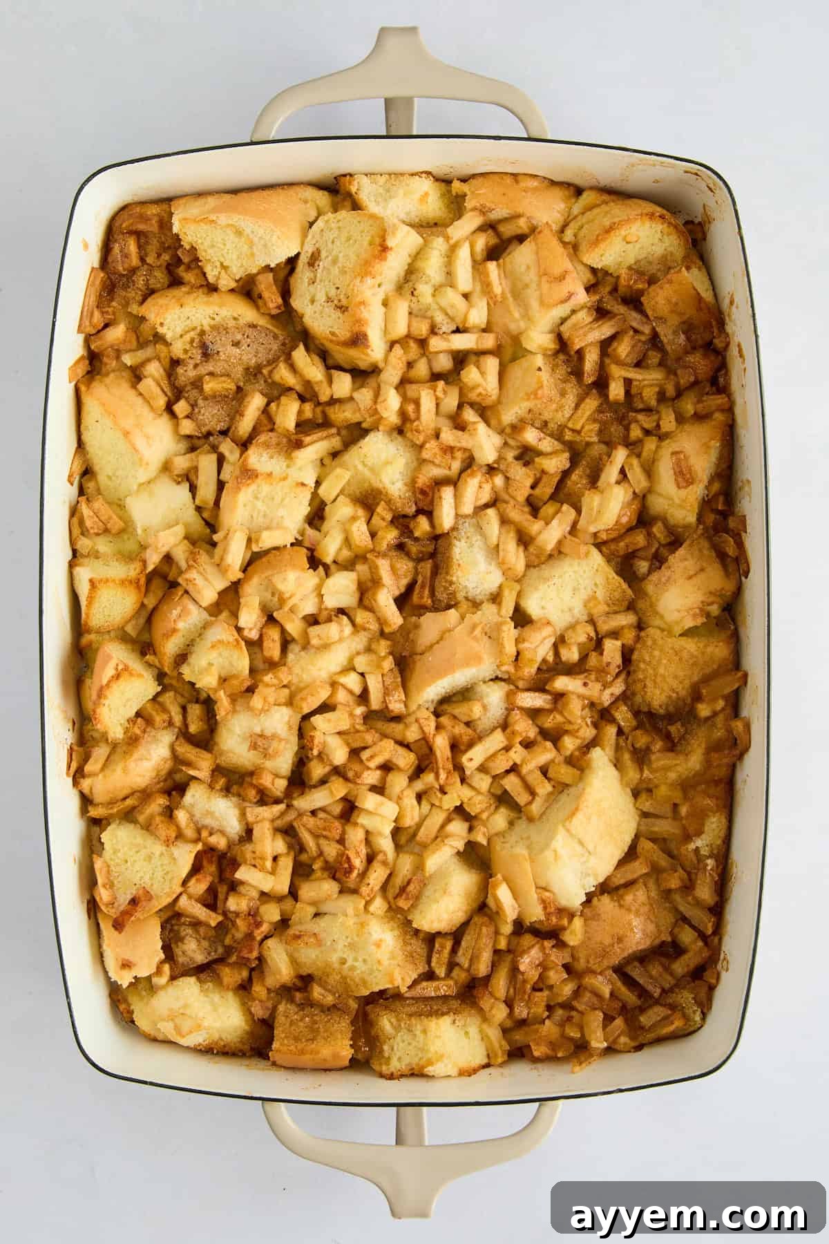 Overhead image of unbaked apple cinnamon french toast casserole. 