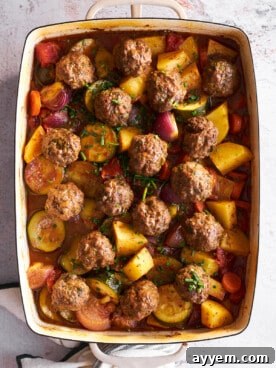 A hearty and comforting Beef Kofta Bake, featuring savory meatballs nestled among colorful vegetables, baked in a rich sauce.