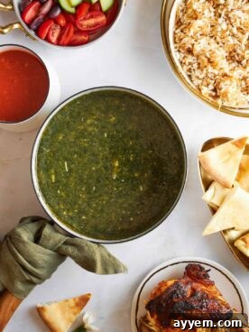 A comforting bowl of Mulukhiya, a traditional Egyptian green stew, served typically with rice or bread.