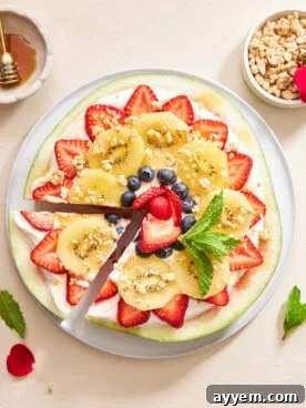 Watermelon pizza with a slice cut.