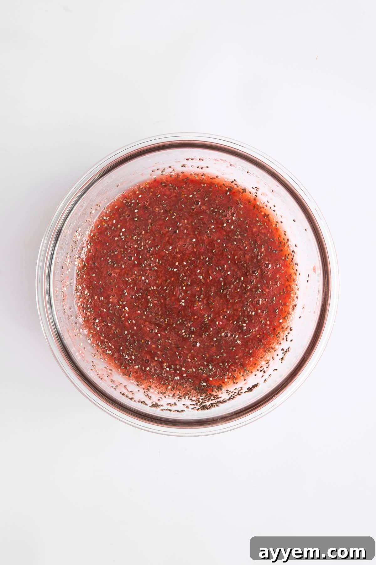 The combined strawberry chia pudding mixture in a bowl, showcasing its creamy texture before chilling, ready to be portioned.