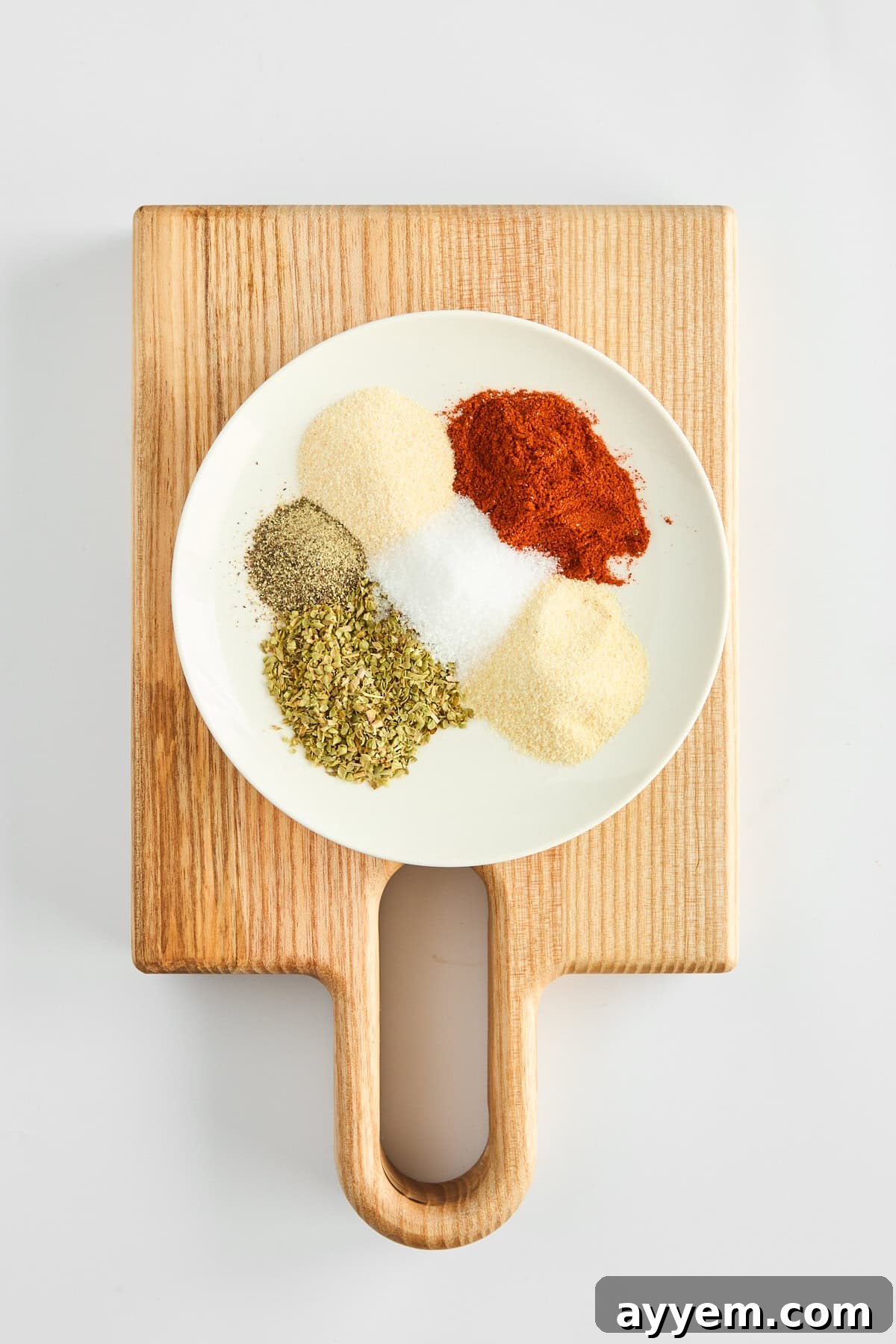 A small bowl filled with a homemade seasoning blend for chicken.