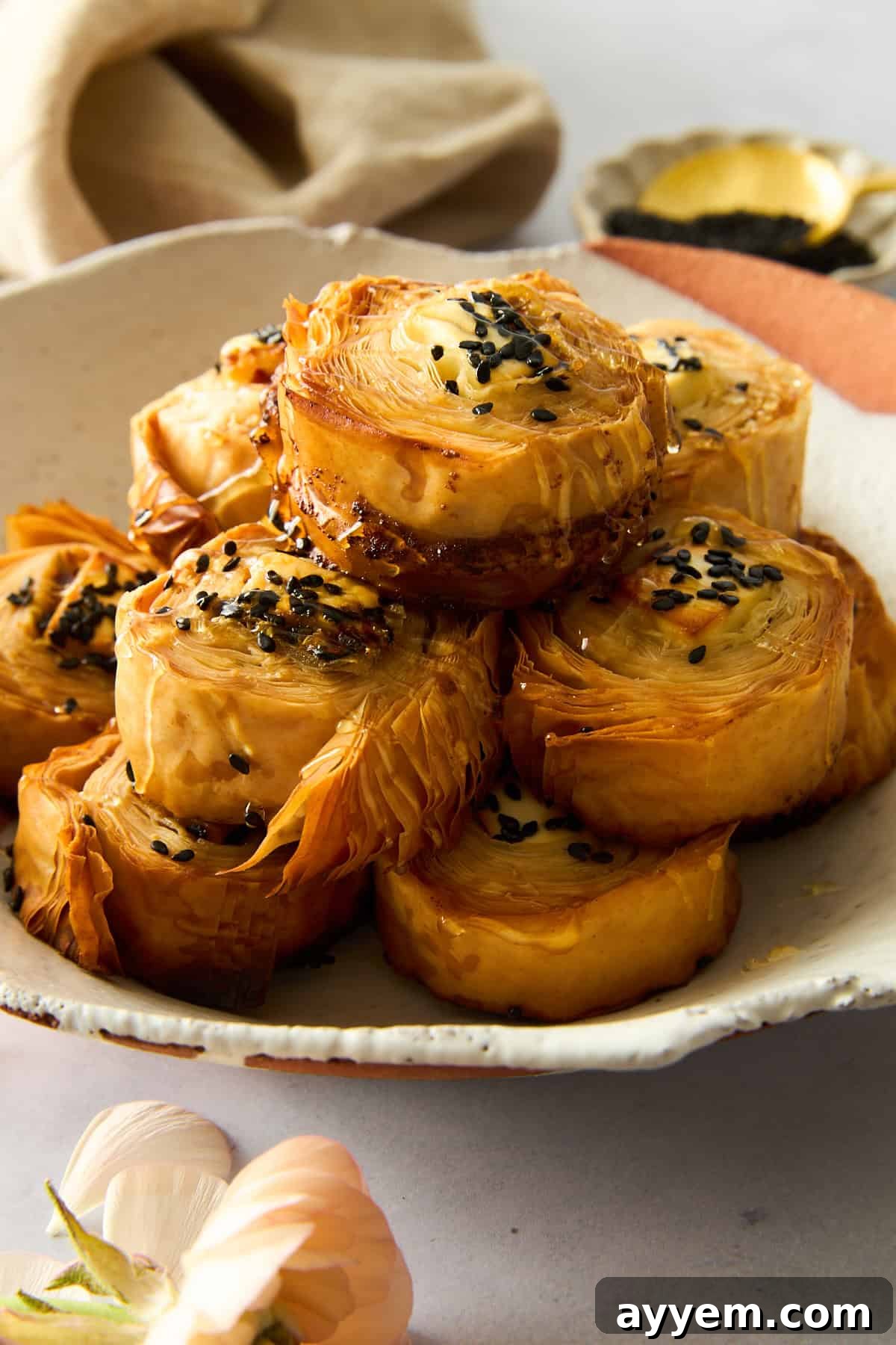 A beautifully arranged plate of hot honey feta phyllo rolls, ready to be served as an appetizer or snack.