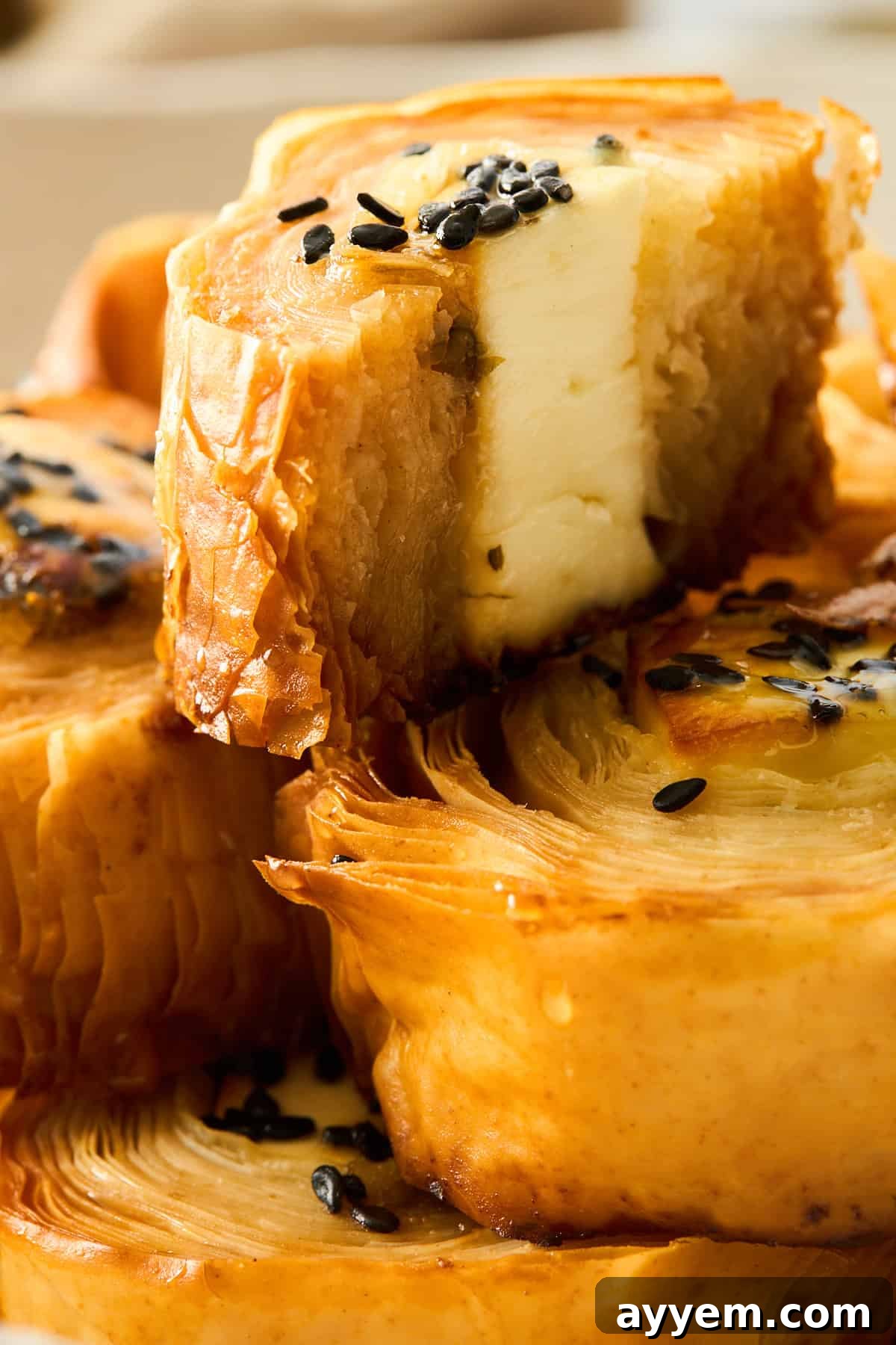 A hot honey feta phyllo roll split in half, revealing its savory and sweet filling.