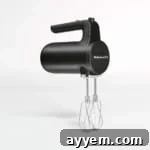 A black cordless hand mixer.