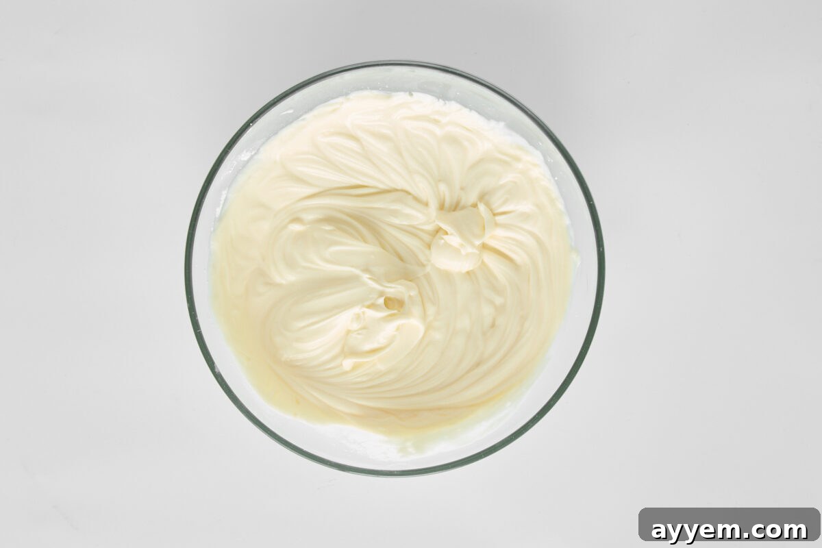 A bowl of blended mascarpone, Greek yogurt, and powdered sugar.