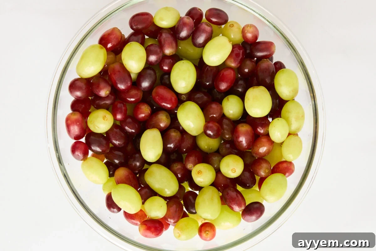 A bowl of red and green grapes.