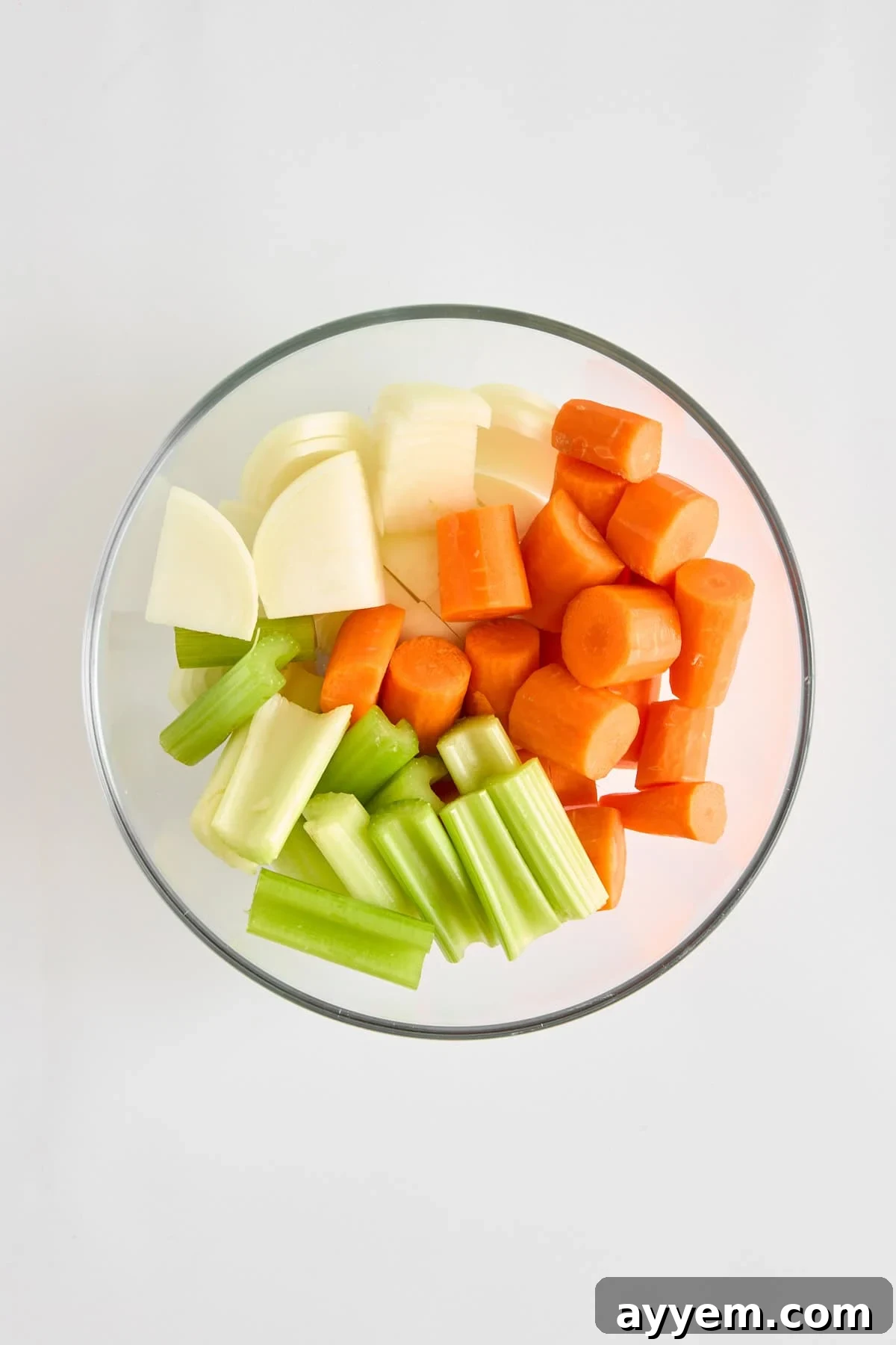 Freshly prepared carrots, celery, and onion, perfectly chopped and ready for simmering in the pastina soup.