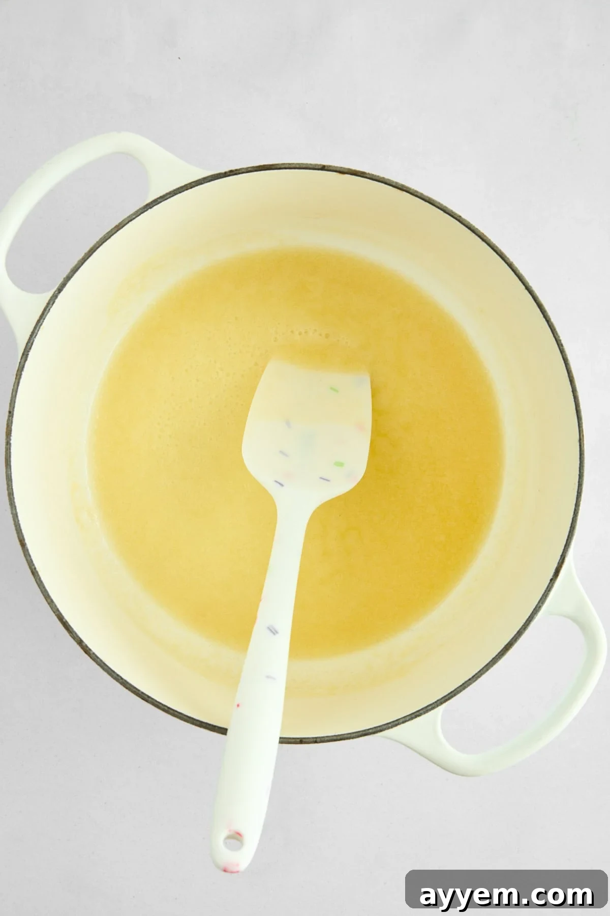 Melted unsalted butter shimmering in a warm pot.
