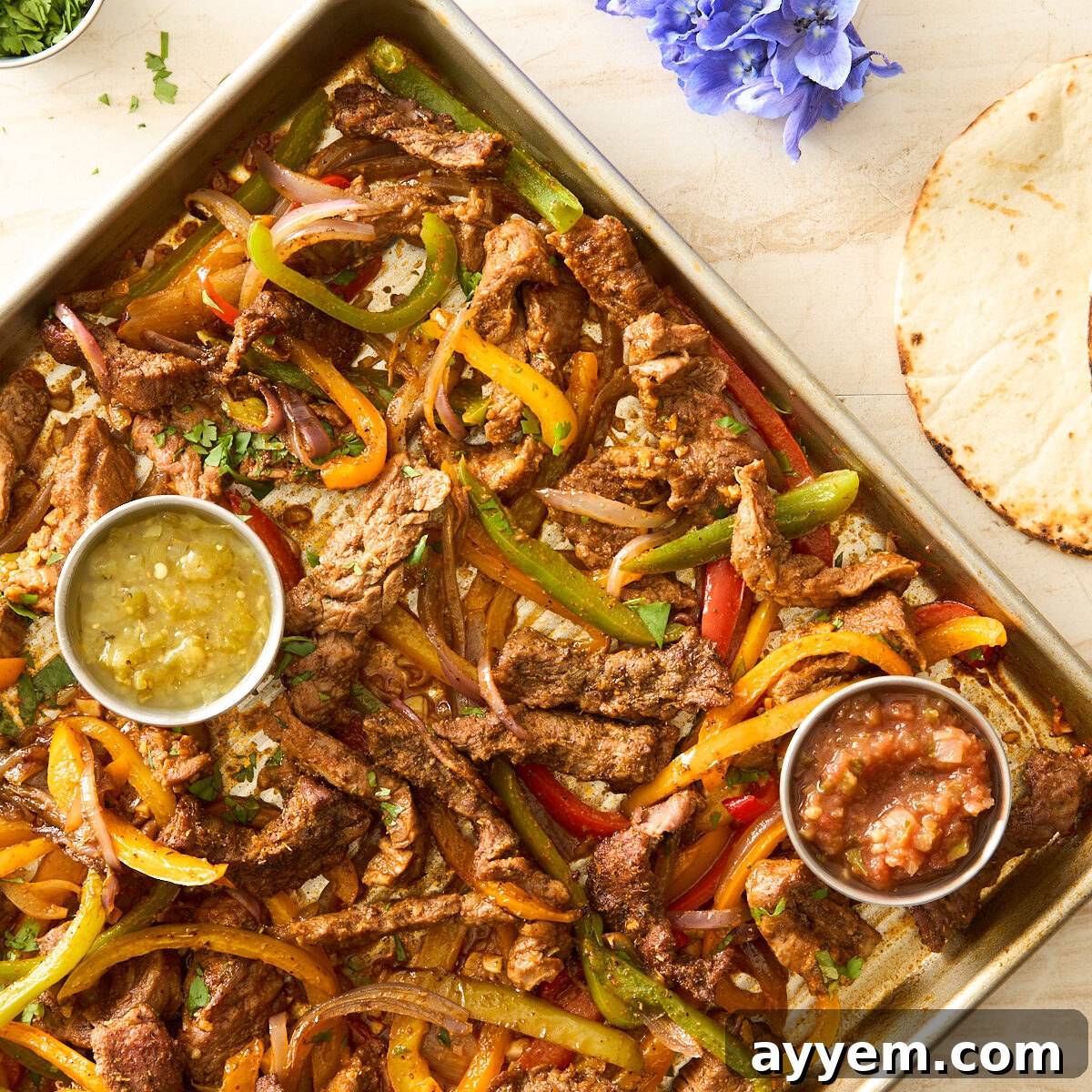 Effortless Sheet Pan Steak Fajitas 4 Sheet pan steak fajitas on a baking sheet.