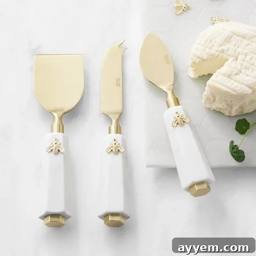 Crafting the Perfect Influencer Box: Our Secrets Revealed 5 Three gold and white cheese knives with bee decorations.