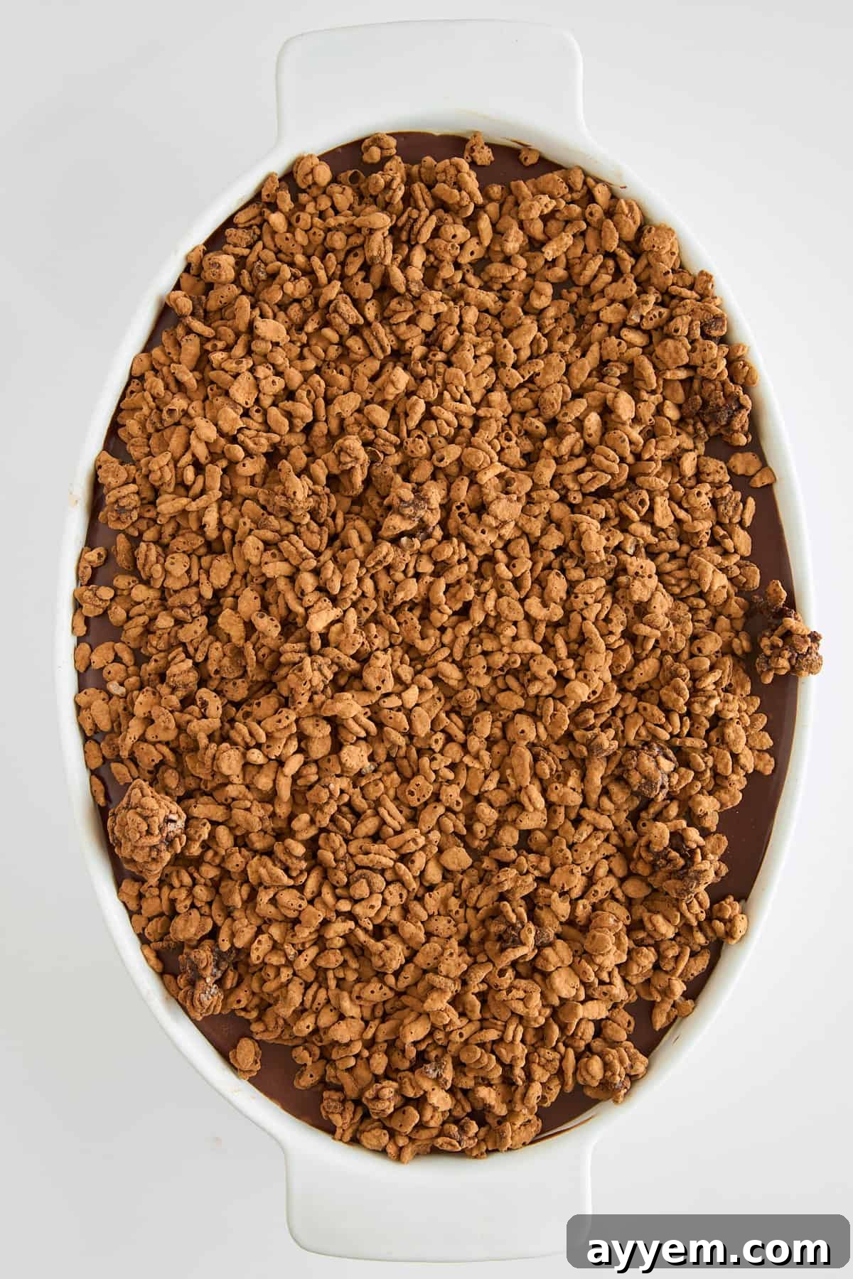 Close-up of the crispy chocolate topping being prepared.