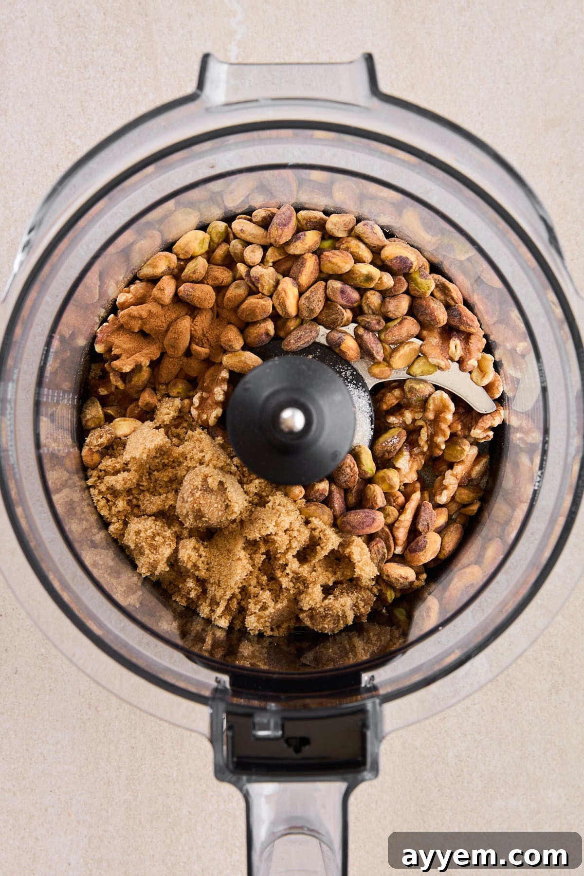 Roughly chopped pistachios and walnuts being processed with brown sugar and cinnamon for the baklava topping.
