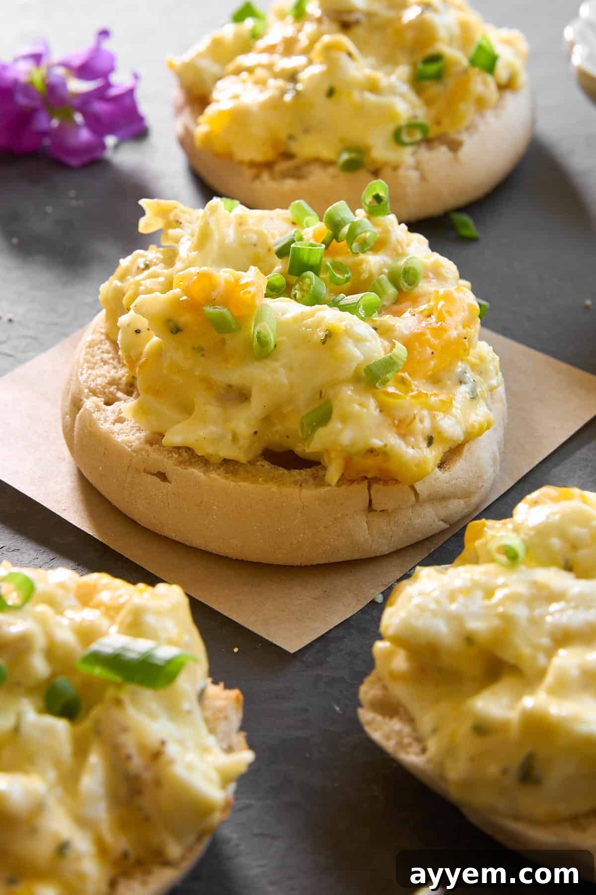 English muffin halves topped with baked scrambled eggs.