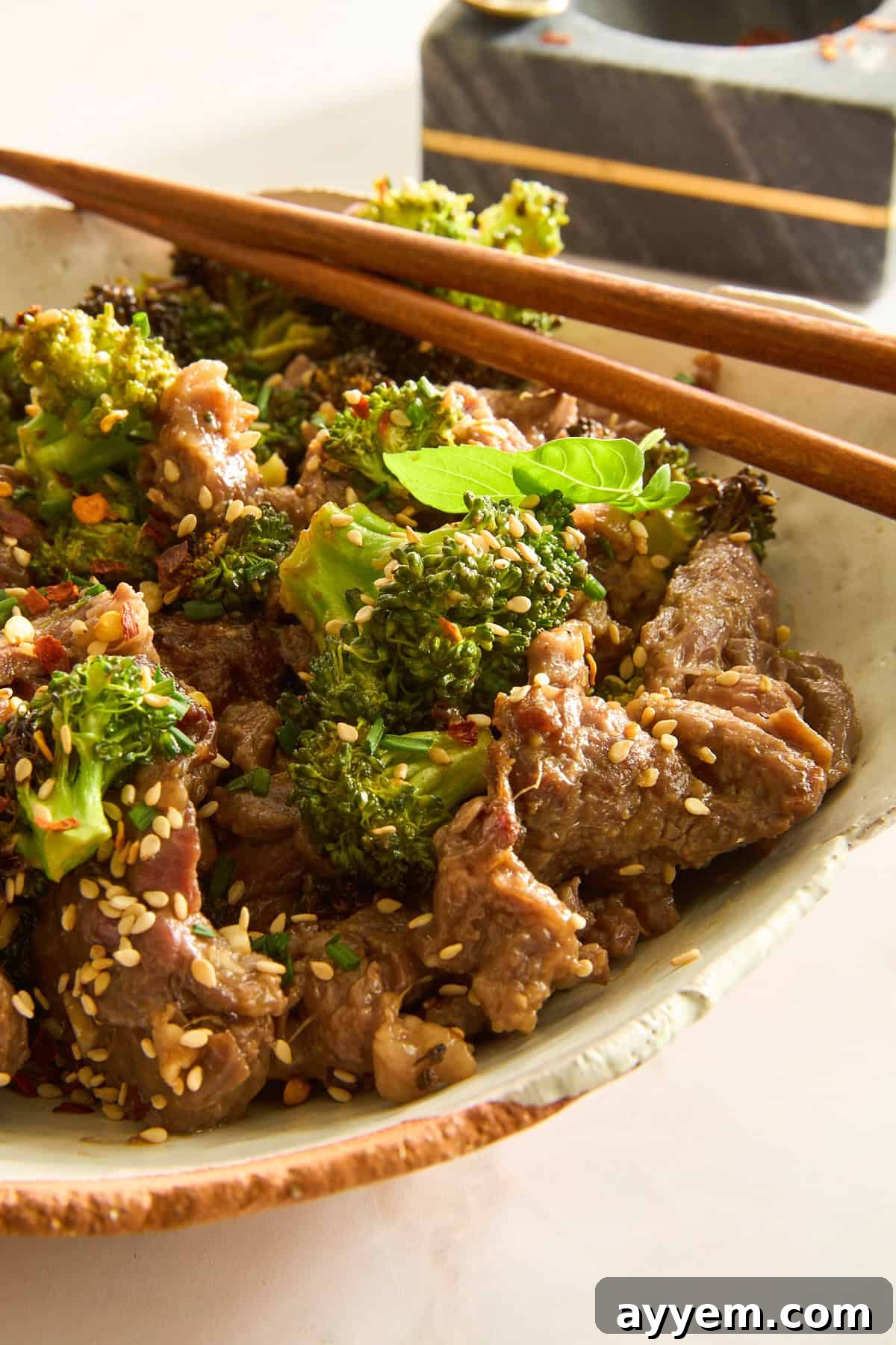 Air Fryer Beef and Broccoli in a bowl with chopsticks on top. 