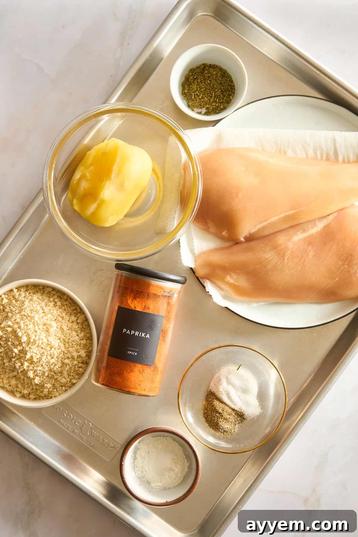 A selection of fresh ingredients laid out, ready to make homemade chicken nuggets.