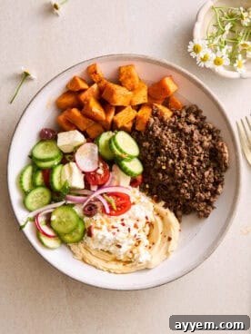 A ground beef bowl with roasted sweet potatoes, fresh veggies, and cottage cheese.
