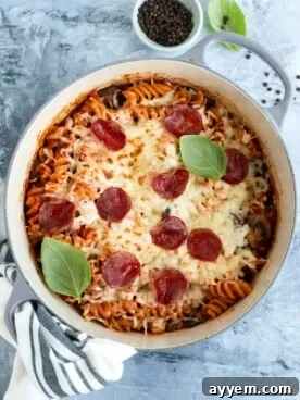 Overhead image of cooked one-pot pizza pasta topped with melted broiled cheese and pepperonis.