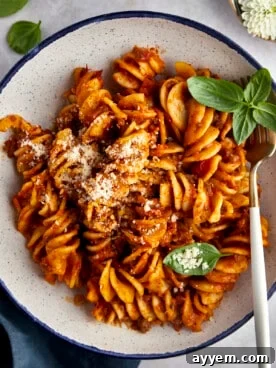 A vibrant bowl of one-pot taco pasta, garnished with fresh cilantro.