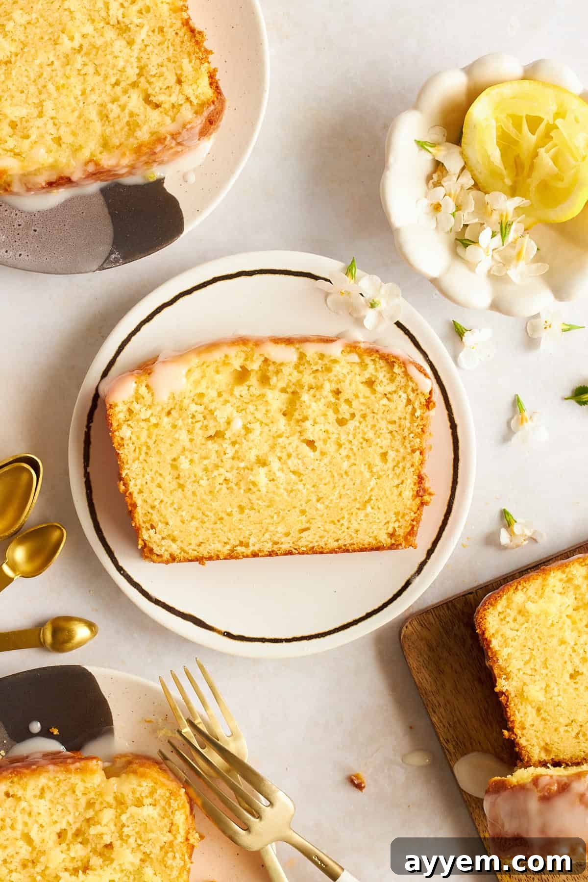 A slice of glazed lemon bread on a plate, showcasing a light and fluffy texture, indicating proper leavening.