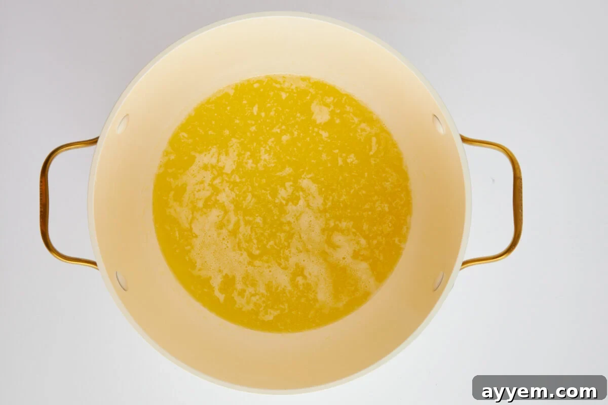 A pot of melted butter shimmering gently over heat.